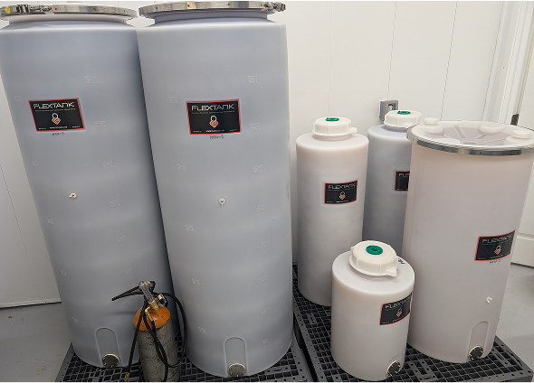 An overlook view of a vineyard. Vine rows stretch very far and roll over the hills.