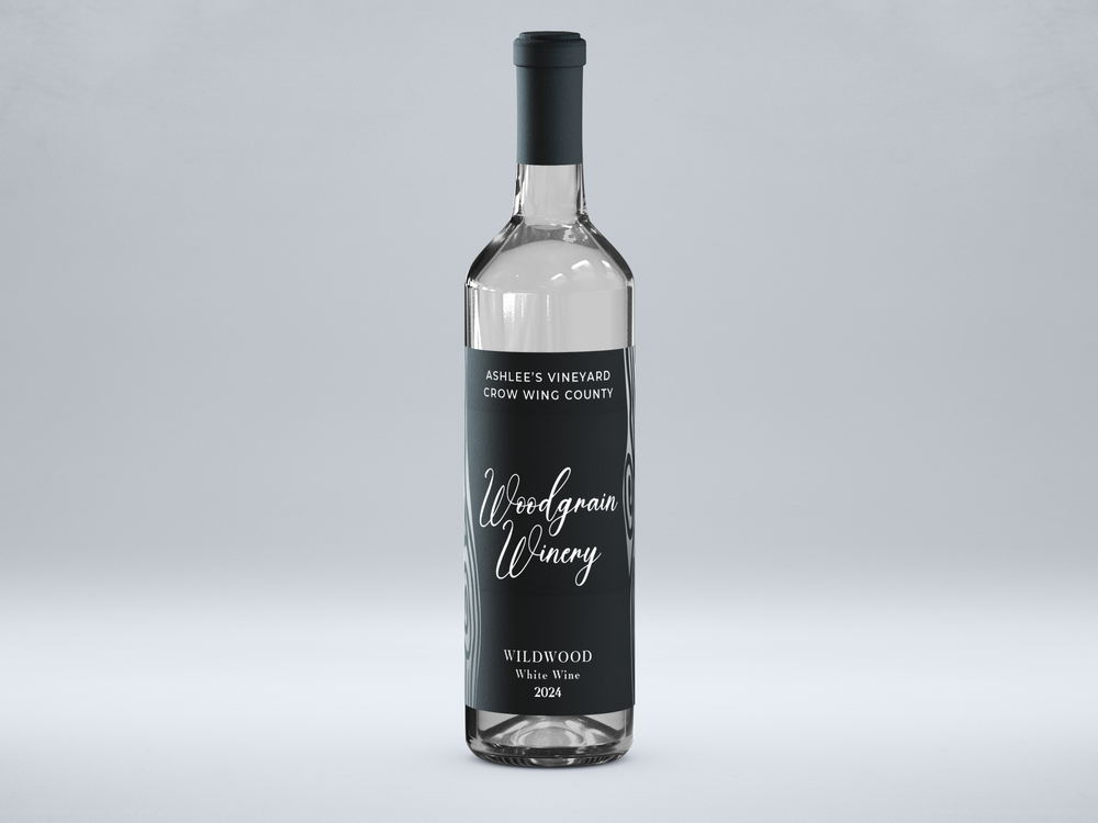 Picture of Woodgrain Winery’s white wine named Wildwood. Bottle standing vertically with black label, silver metal flake woodgrain, white text. Viewed from the front.